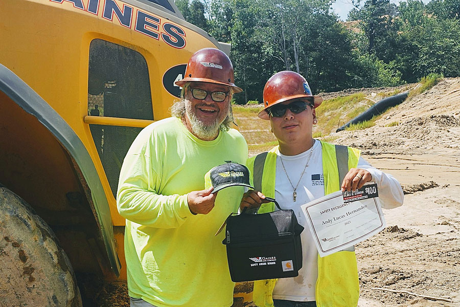Gaines and Company’s Safety Manager awards North Carolina’s Quarterly Safety Award in front of large equipment