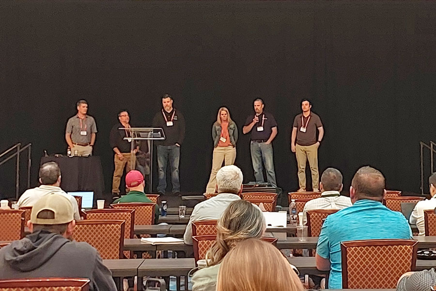 NCI board members – including Gaines and Company’s Dominic Pope – on stage speaking at the Spring 2025 conference